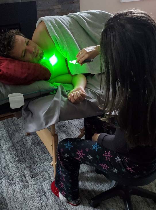 Rachel Celler administering green laser therapy